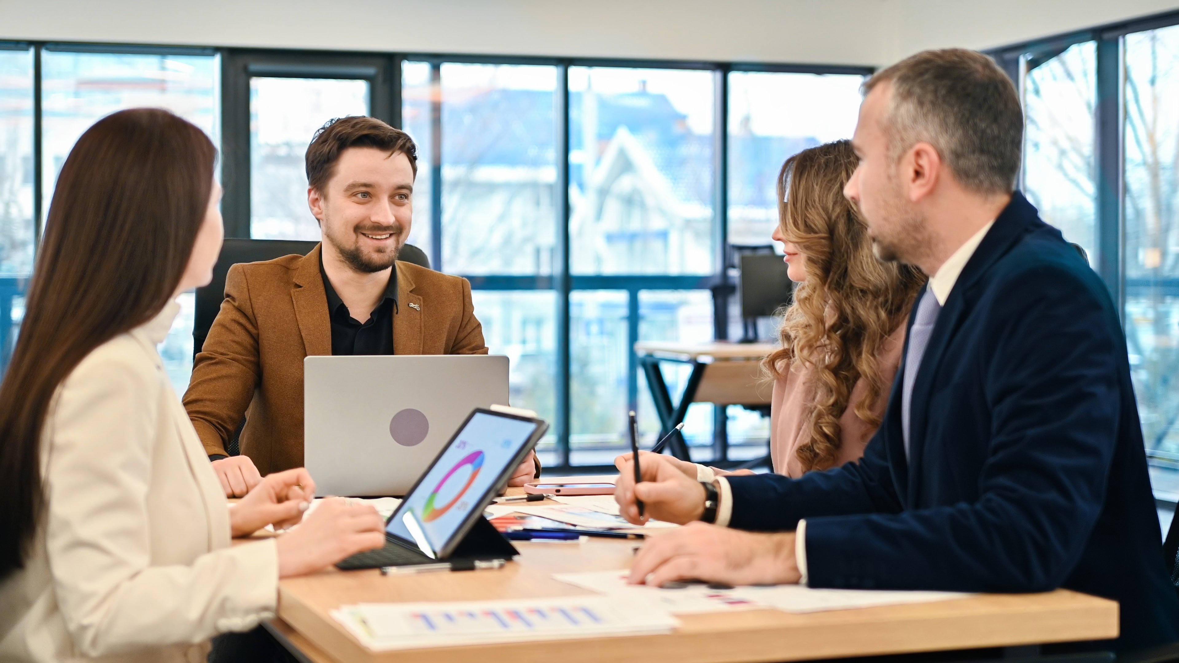 Colleagues discussing business in a bright office